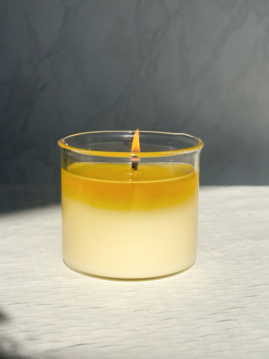 A lit massage candle with hot oil